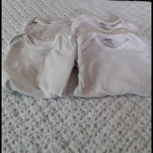 Four white onesies